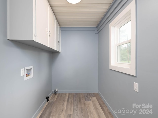 clothes washing area featuring cabinets, washer hookup, and light wood-type flooring