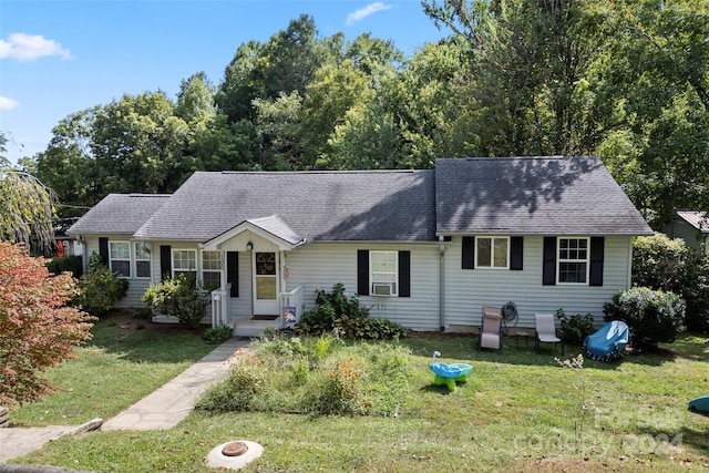 view of front of house featuring cooling unit and a front yard