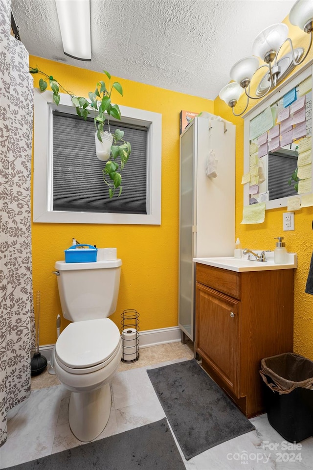 bathroom featuring a textured ceiling, vanity, toilet, and a shower with shower curtain