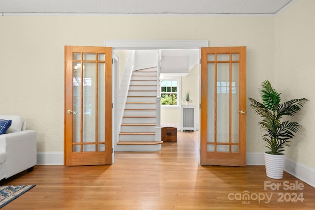 foyer featuring wood-type flooring and radiator heating unit