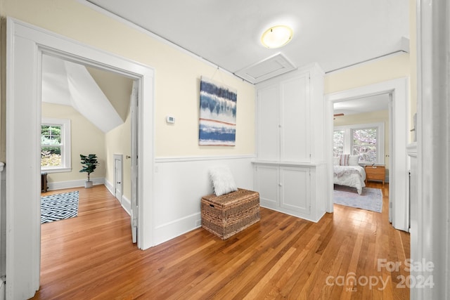 hallway with light hardwood / wood-style floors