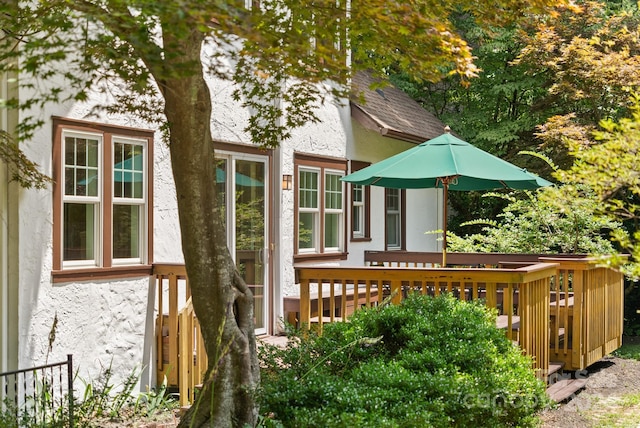 back of property with a wooden deck