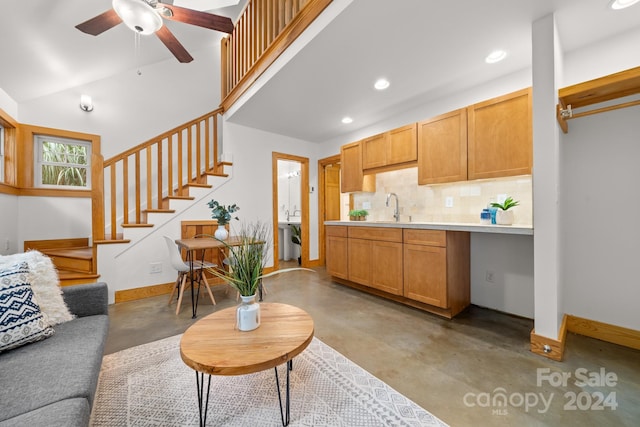 interior space with ceiling fan, sink, and tasteful backsplash