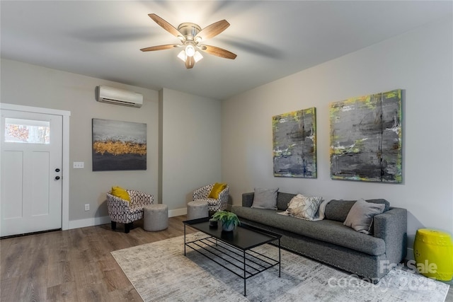 living room featuring hardwood / wood-style flooring, ceiling fan, and a wall mounted AC