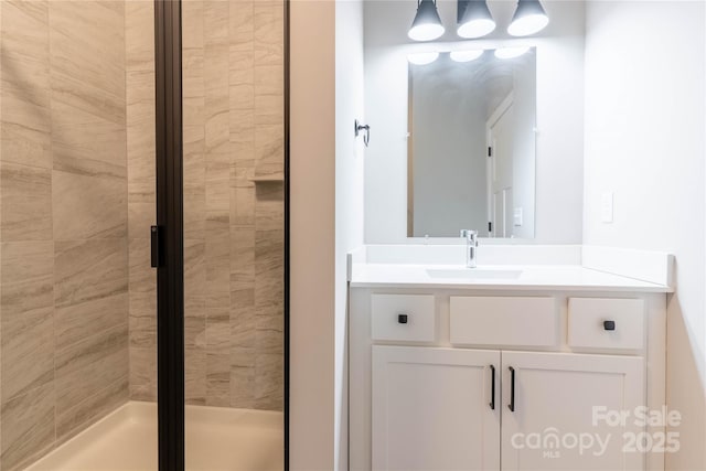 bathroom with vanity and a shower with door