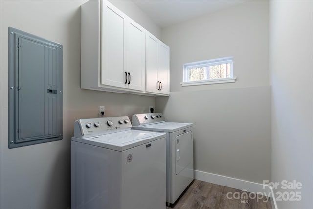 laundry room featuring cabinets, dark hardwood / wood-style flooring, electric panel, and independent washer and dryer