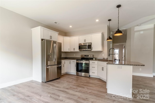 kitchen featuring sink, white cabinetry, hanging light fixtures, kitchen peninsula, and stainless steel appliances