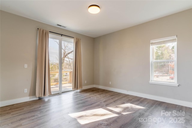 unfurnished room featuring a healthy amount of sunlight and light wood-type flooring