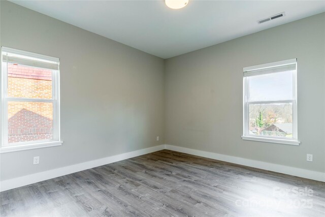 empty room with light hardwood / wood-style flooring