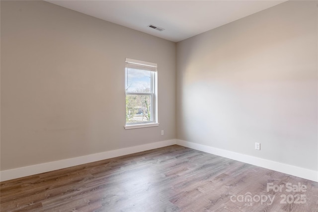 spare room with light hardwood / wood-style flooring