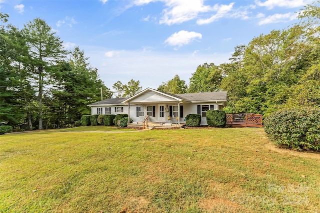 ranch-style house featuring a deck and a front lawn