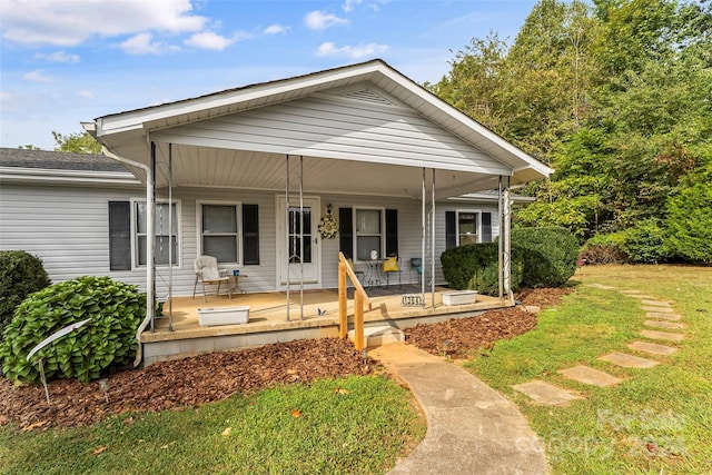 view of front of property with covered porch and a front yard