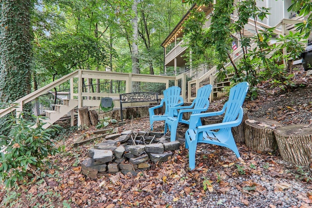 view of yard featuring a fire pit and a wooden deck