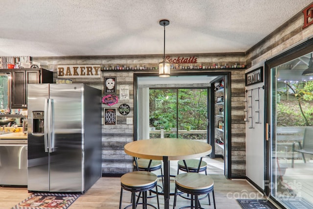 interior space with a textured ceiling and light hardwood / wood-style flooring