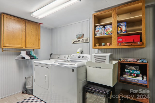 laundry area with washing machine and dryer and cabinets