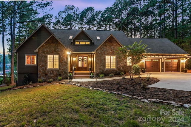 view of front of property with a lawn and a garage