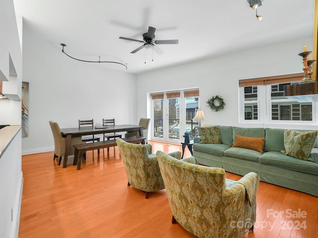 living room featuring ceiling fan and hardwood / wood-style flooring