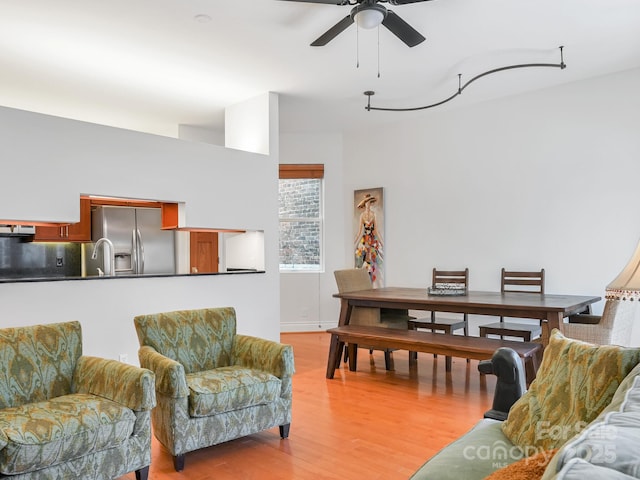 living area featuring a ceiling fan and light wood-style floors