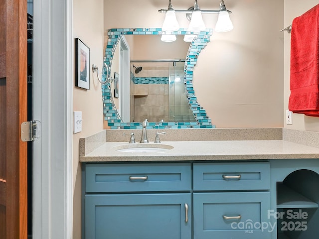 bathroom featuring vanity and a shower stall