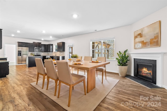 dining area featuring light hardwood / wood-style flooring and sink