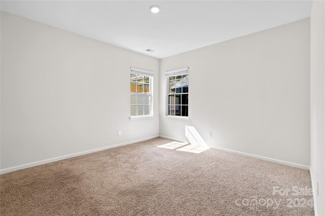 unfurnished room featuring carpet flooring