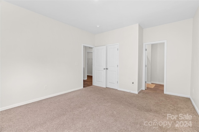 unfurnished bedroom featuring a closet and carpet floors