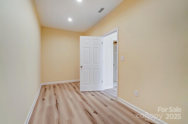 empty room with recessed lighting, light wood-style floors, visible vents, and baseboards