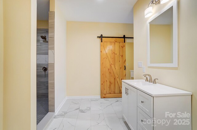 full bathroom featuring baseboards, marble finish floor, vanity, and a tile shower