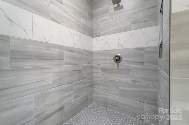 full bath with a tile shower