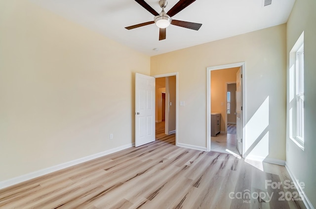 unfurnished bedroom featuring visible vents, ceiling fan, light wood-type flooring, and baseboards