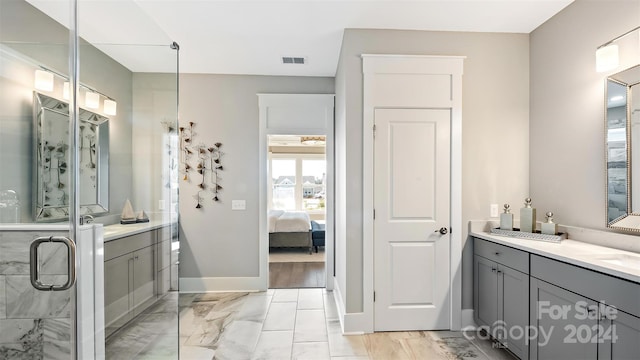 bathroom with hardwood / wood-style floors, walk in shower, and vanity