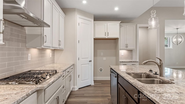 kitchen featuring white cabinetry, pendant lighting, a sink, and exhaust hood