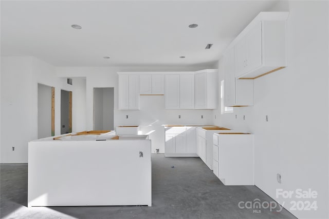 kitchen with a center island and white cabinetry