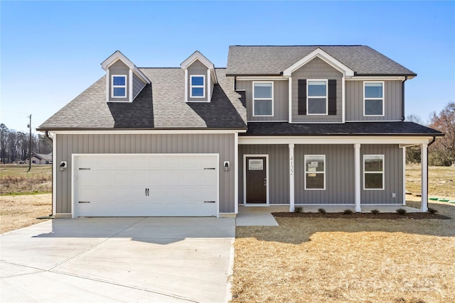 view of front facade with an attached garage, covered porch, concrete driveway, and roof with shingles