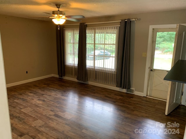 spare room featuring a textured ceiling, dark hardwood / wood-style flooring, and ceiling fan