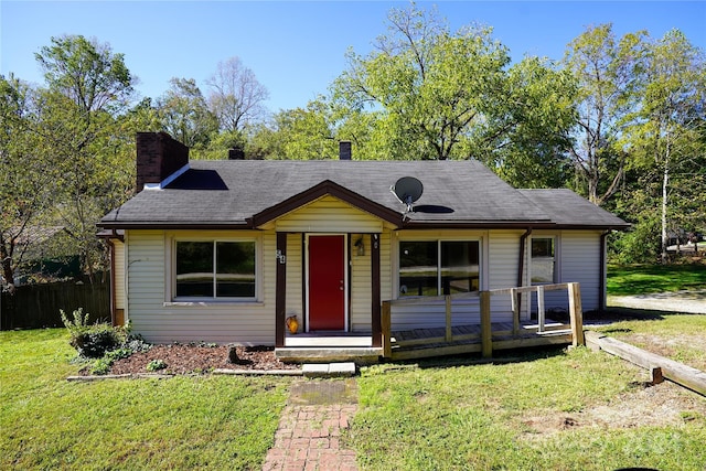 view of front facade featuring a front yard and a wooden deck