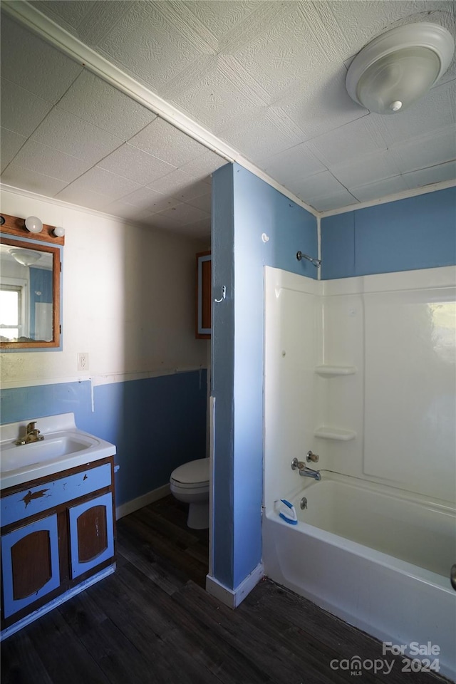 full bathroom featuring vanity, bathing tub / shower combination, hardwood / wood-style floors, and toilet