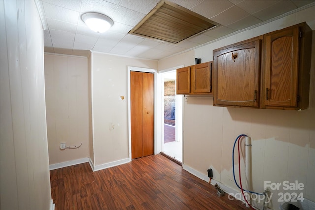 laundry room featuring cabinets and dark hardwood / wood-style flooring