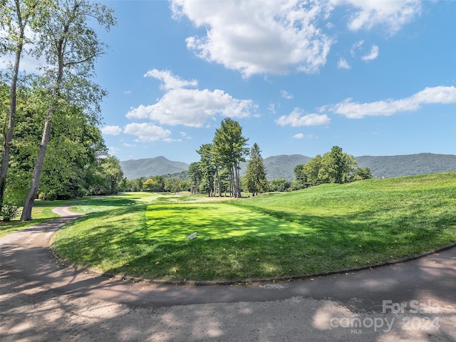 exterior space featuring a lawn and a mountain view