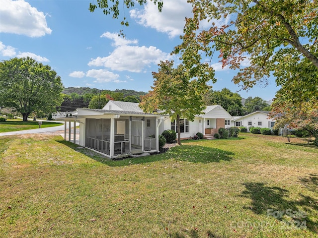 view of yard featuring a sunroom