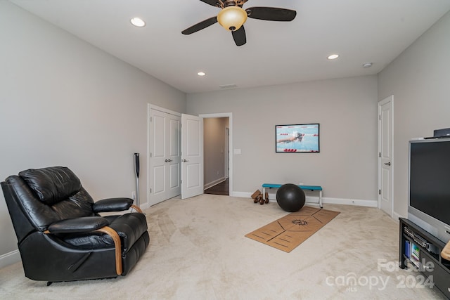 sitting room with carpet flooring and ceiling fan