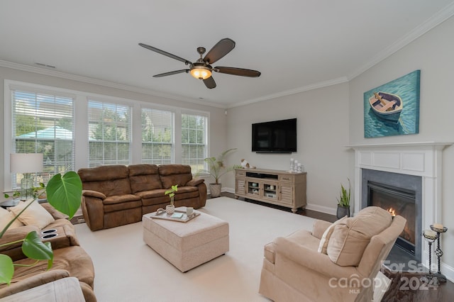 living room featuring ornamental molding, a wealth of natural light, ceiling fan, and hardwood / wood-style flooring