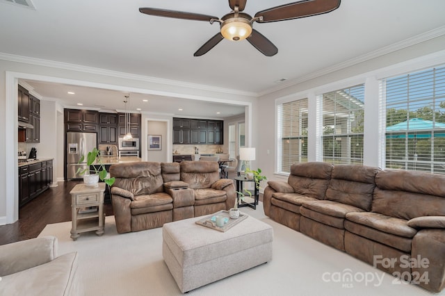 living room featuring crown molding, dark hardwood / wood-style flooring, and ceiling fan