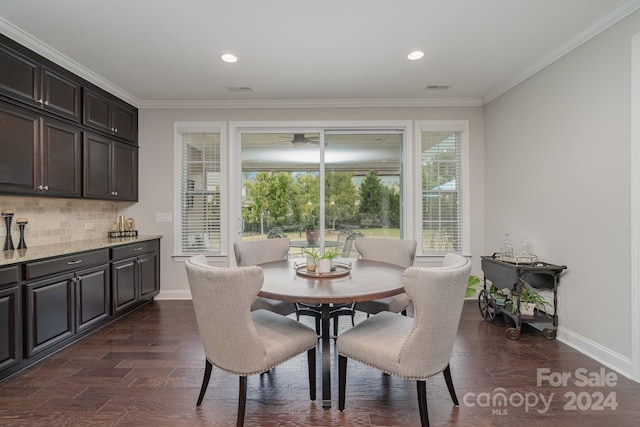 dining area with crown molding and dark hardwood / wood-style floors