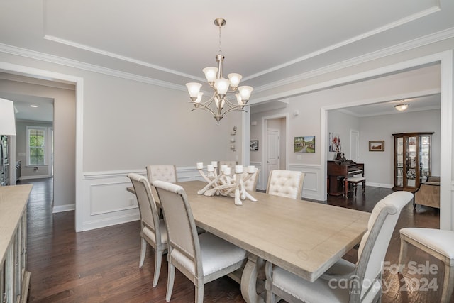 dining area with ornamental molding, dark hardwood / wood-style flooring, and a chandelier