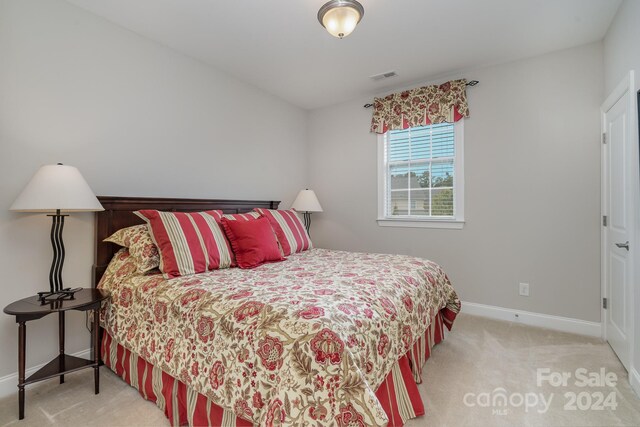 bedroom with light carpet