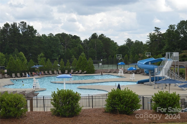 view of pool featuring a water slide and a patio area