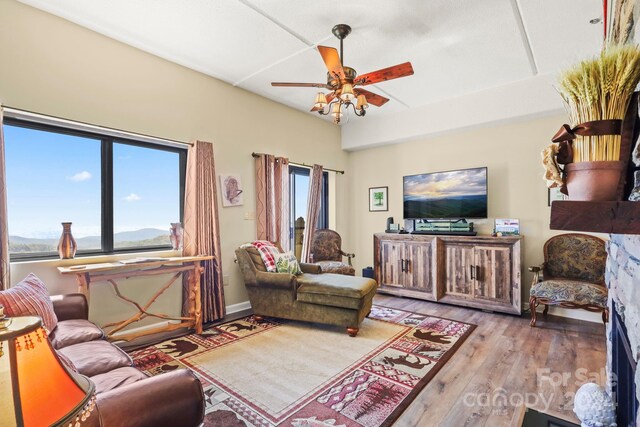 living room with light wood-type flooring and ceiling fan