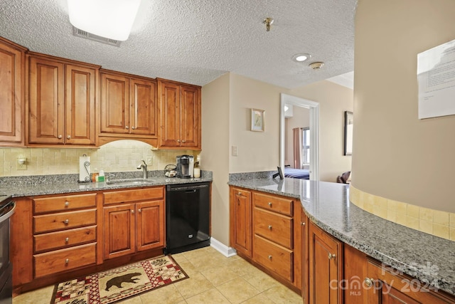 kitchen with backsplash, light tile patterned floors, dishwasher, sink, and dark stone counters