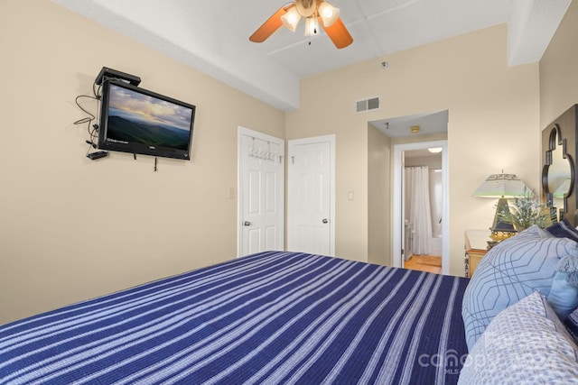 bedroom with connected bathroom and ceiling fan